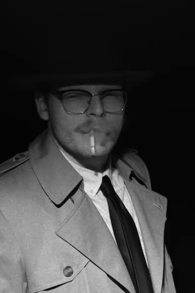 James Snubinsky in trench coat and fedora